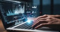 Hands typing on a laptop displaying complex financial data and charts with glowing effects Royalty Free Stock Photo