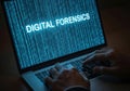 Hands typing on laptop displaying digital forensics code and binary data Royalty Free Stock Photo