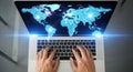 Hands typing on laptop displaying glowing world map with digital connections global technology concept Royalty Free Stock Photo
