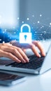 Hands typing on laptop with glowing padlock icon, representing data security and online privacy. Royalty Free Stock Photo