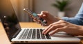 Hands typing on laptop and holding smartphone for modern technology and productivity Royalty Free Stock Photo