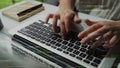 Hands Typing on Laptop Keyboard with Coding Text Overlay in Modern Office Environment Reflecting Technology and Software Royalty Free Stock Photo