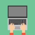 Hands typing on laptop keyboard.