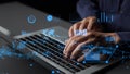 Hands typing on laptop keyboard with digital analytics graphs and charts overlay showcasing data analysis and technology Royalty Free Stock Photo