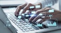 Hands typing on a laptop keyboard with digital data visualizations overlaying the scene Royalty Free Stock Photo