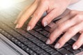 Hands typing on a laptop keyboard, light effect Royalty Free Stock Photo