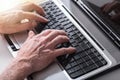 Hands typing on a laptop keyboard, light effect Royalty Free Stock Photo