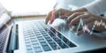 Hands typing on a laptop keyboard, with overlays of digital graphs and data visualizations Royalty Free Stock Photo