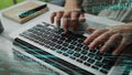 Hands Typing on Laptop Keyboard with Programming Code and Digital Data Overlay in Modern Workspace Environment xenic Royalty Free Stock Photo