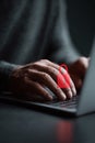 Hands typing on a laptop with a red unlocked padlock overlay. Represents cyber security risks, online safety, data breach, and Royalty Free Stock Photo