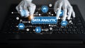 Hands typing on laptop showcasing data analytics with graphs, statistics, cloud computing, and machine learning concepts Royalty Free Stock Photo