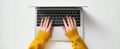 The hands typing on a laptop with vibrant yellow sweater. AI generated image Royalty Free Stock Photo