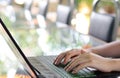 Hands typing on notebook or lap top on table in coffee shop Royalty Free Stock Photo
