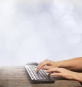 Hands typing on a remote wireless computer keyboard Royalty Free Stock Photo