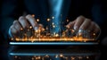 futuristic digital data visualization with glowing orange light effects emerging from a tablet held by a person in dark clothing Royalty Free Stock Photo