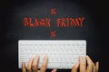 Hands typing on a white computer keyboard, Black background,and text, Black Friday Royalty Free Stock Photo
