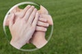 Hands uniting in glass sphere on grass Royalty Free Stock Photo