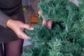Hands unravelling a fake Christmas tree Royalty Free Stock Photo