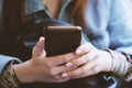 Hands of unrecognizable young woman using smartphone or mobile phone Royalty Free Stock Photo