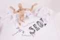 SEO Help wooden jointed manikin doll hands up in the air crumbled up paper in background