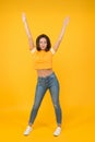 Hands up. Sexy woman yellow background. Pretty woman in casual style. Sensual woman with beauty look. Sexi woman with