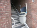 Hands up stairlift or chair lift at the bottom of the ground floor stairway