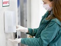 Hands using automatic sanitizer dispenser at supermarket. Disinfectant in a shopping mall during the coronavirus