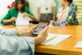 Hands using cell phone with stock money graph with group of business people. Royalty Free Stock Photo