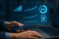 Hands using smartphone and laptop with financial data interface Royalty Free Stock Photo