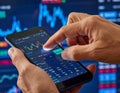 Hands Using Smartphone with Stock Market Data Display Royalty Free Stock Photo