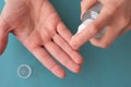 Hands using spray bottle with antiseptic liquid as concept of health care, self-hygiene and prevention of coronavirus spreading