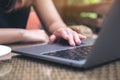 Hands using and touching on laptop touchpad on wooden table Royalty Free Stock Photo