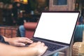 Hands using and typing on laptop with blank white desktop screen while sitting outdoor Royalty Free Stock Photo