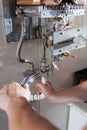 Hands using wrench to repair the gas water heater