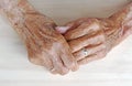 The hands of a very old woman. Old woman`s hands on a table Royalty Free Stock Photo