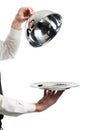 Hands of waiter with cloche lid Royalty Free Stock Photo