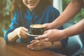 Hands of waiter serving a cup of coffee to customer Royalty Free Stock Photo