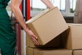 Hands of warehouse worker lifting box Royalty Free Stock Photo