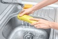 hands washing and cleaning squash or zucchini vegetable under stream of cold water from the kitchen faucet. Hygiene and Royalty Free Stock Photo