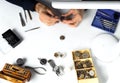 The hands of a watchmaker repairing a mechanical watch.