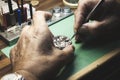 The hands of a watchmaker repairing a watch