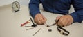 Hands of a watchmaker with tools while repairing some watches Royalty Free Stock Photo