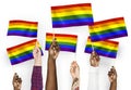 Hands waving colorful rainbow flags