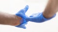 Hands wearing blue medical latex gloves Protection against flu, virus and coronavirus. Health care and surgical concept. Correct