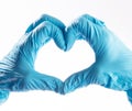 Hands wearing PPE gloves forming a shape of a heart