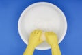 Hands wearing rubber gloves, Wringing out sponge