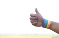 Hands wears rainbow colors stripes wristband, Thumbs up. Concept, Lgbtq+ celebration in pride month, Royalty Free Stock Photo