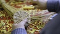 Hands weaving the bottom of a straw basket. ART. A man weaves a round part of straw and twigs with his hands. Crafts are Royalty Free Stock Photo