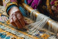 Hands weaving intricate patterns in textiles