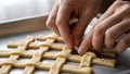 Hands Weaving Lattice Pattern with Dough Strips for Pie Crust Royalty Free Stock Photo